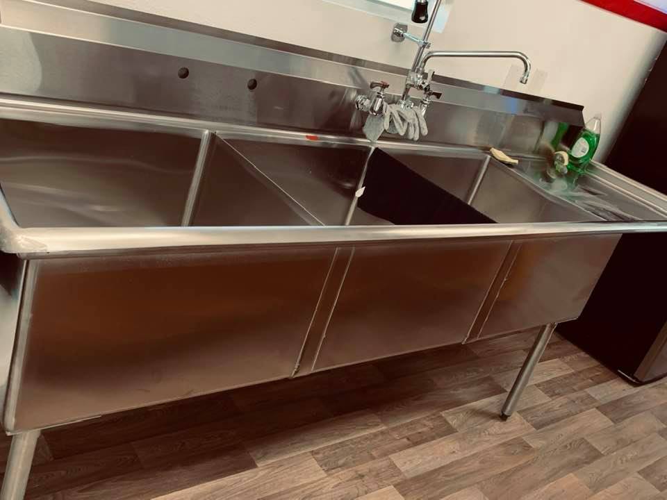 The 3 headed monster that is our commercial sink. The compartments are big enough to give our large dogs a bath!
