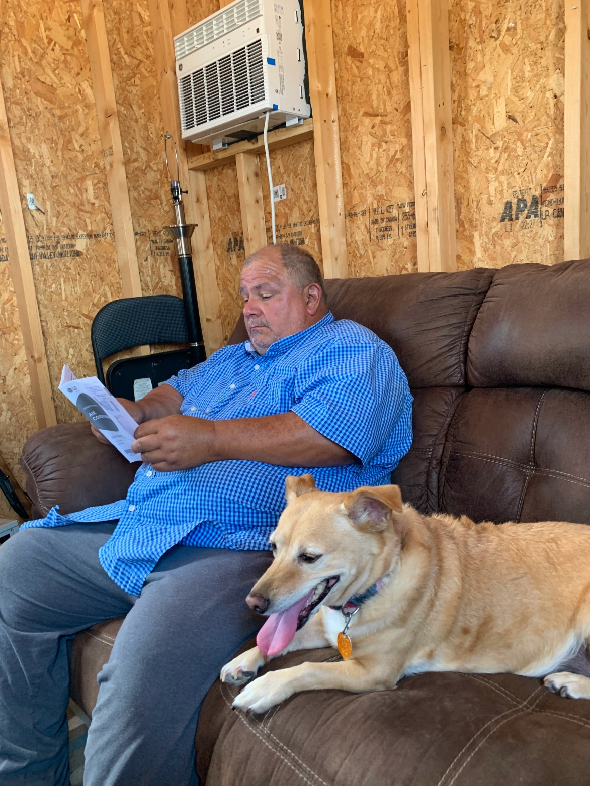 David & Ethel on the couch where we slept in the uninsulated shed. Note the portable A/C unit above David's head, running with a generator.