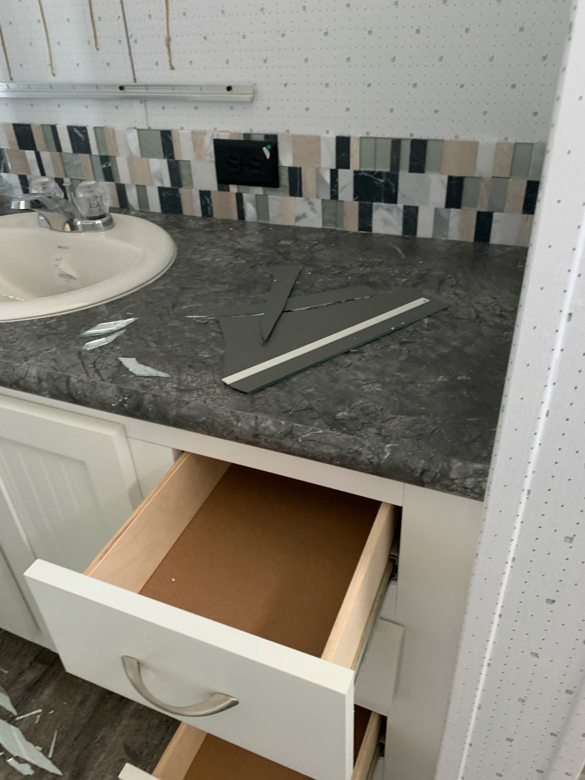 You can see the lines of glue on the bathroom wall where the mirror was until it fell off and broke during transport while moving out of San Antonio.