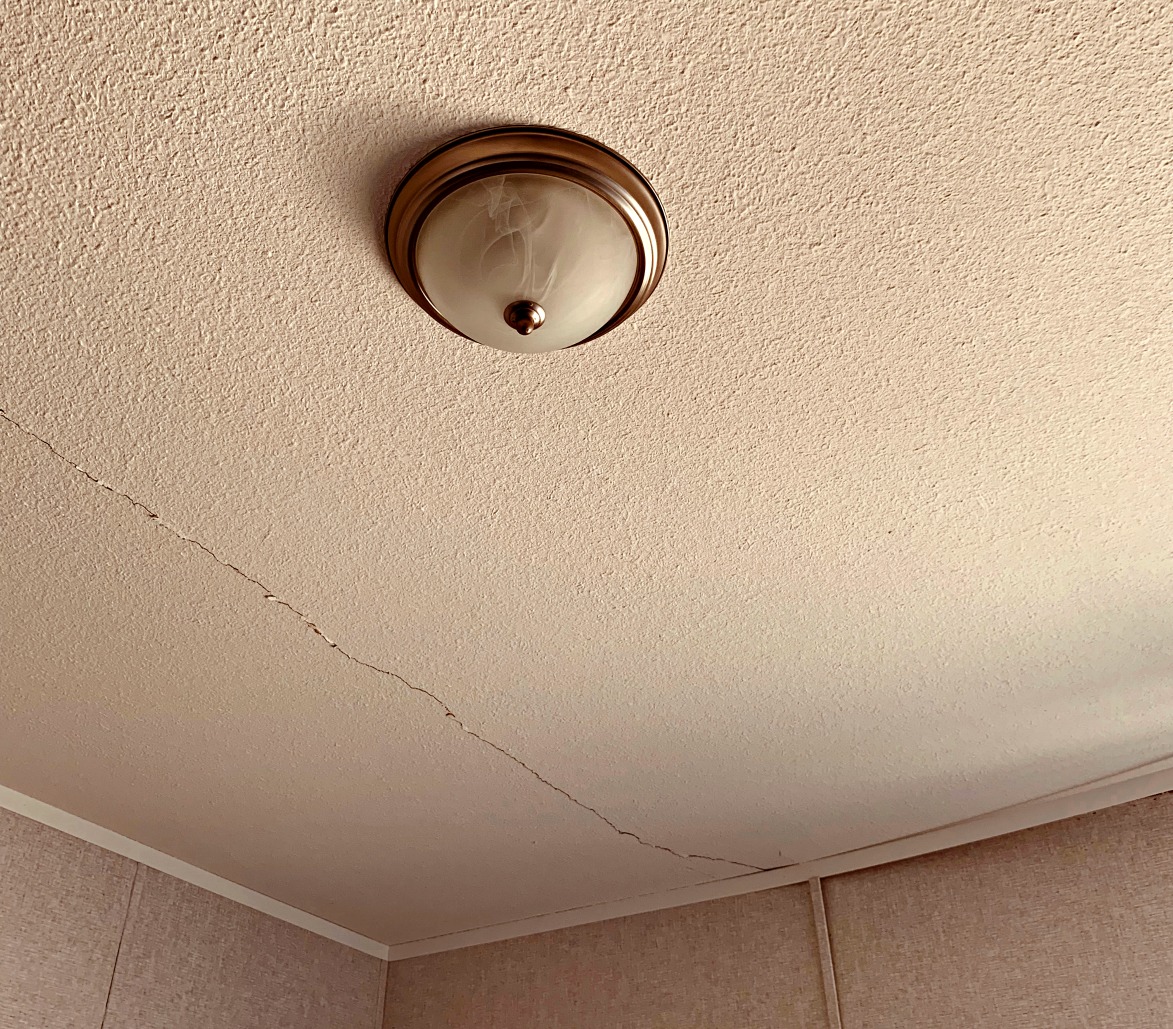 A cracked ceiling in one of the bedrooms of our new home will need to be fixed.