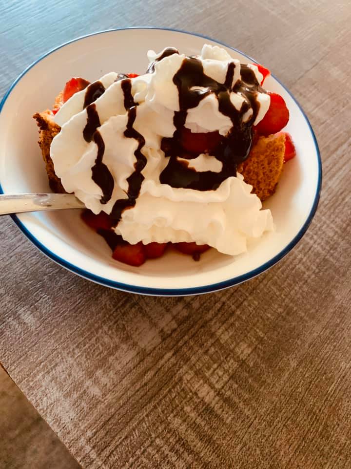 Angelfood bundt cake served with Poteet strawberries, Ghirardelli chocolate sauce, and whipped cream is delicious.