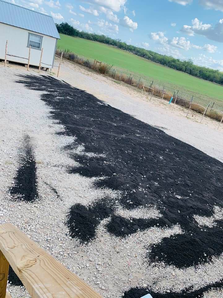 Two men in a red truck were shoveling black stones onto our parking lot. I could not reach David. When I went to his office, one of them told me he was giving it to us. Yes, for $800.00!