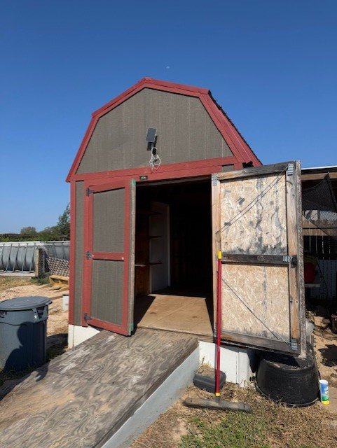 The outside of the barn shed. There is also a door on the side.