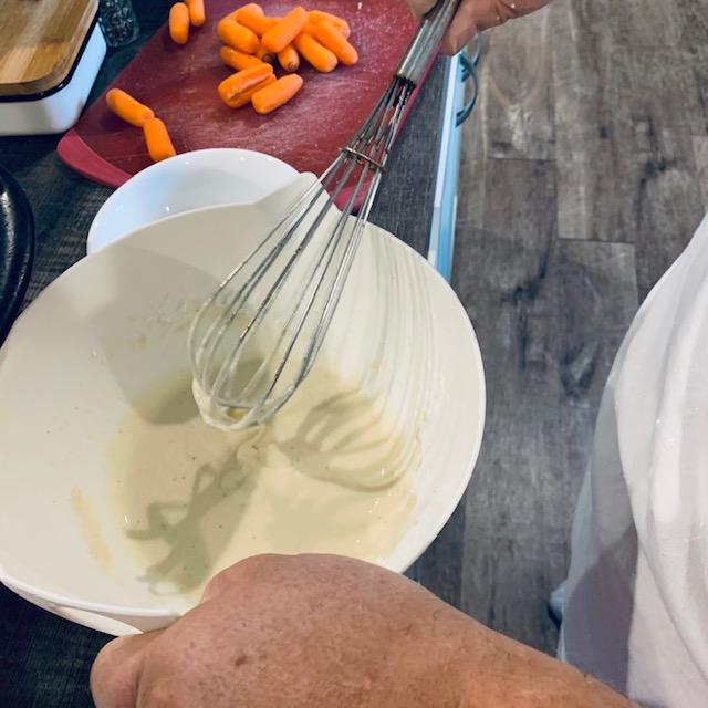 The batter is being mixed for the meat.