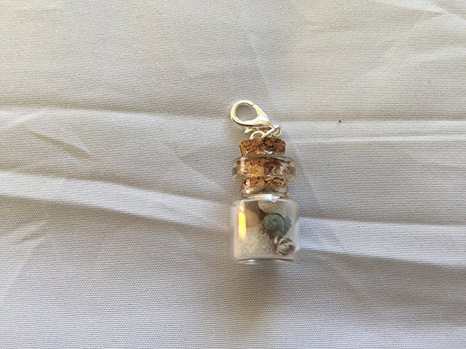 Mini glass jars filled with beach sand and tiny shells make great pendants. I have sold these at craft shows.