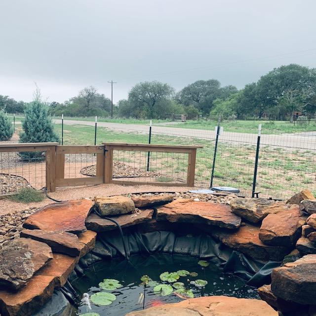 This photo was taken behind the pond facing out to FM 2504. You can see the trees in front of the store next to the road as well as the clouds. This photo was taken behind the pond facing out to FM 2504. You can see the trees in front of the store next to the road as well as the clouds.