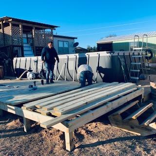 Nacho and Mark are adding to the deck they built in December, making it as long as the pool deck.
