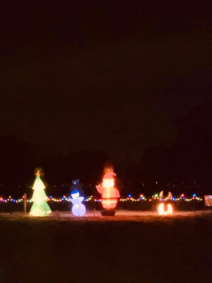 Our Christmas decorations at night. These are blowups that face the Farm to Market Road out front.
