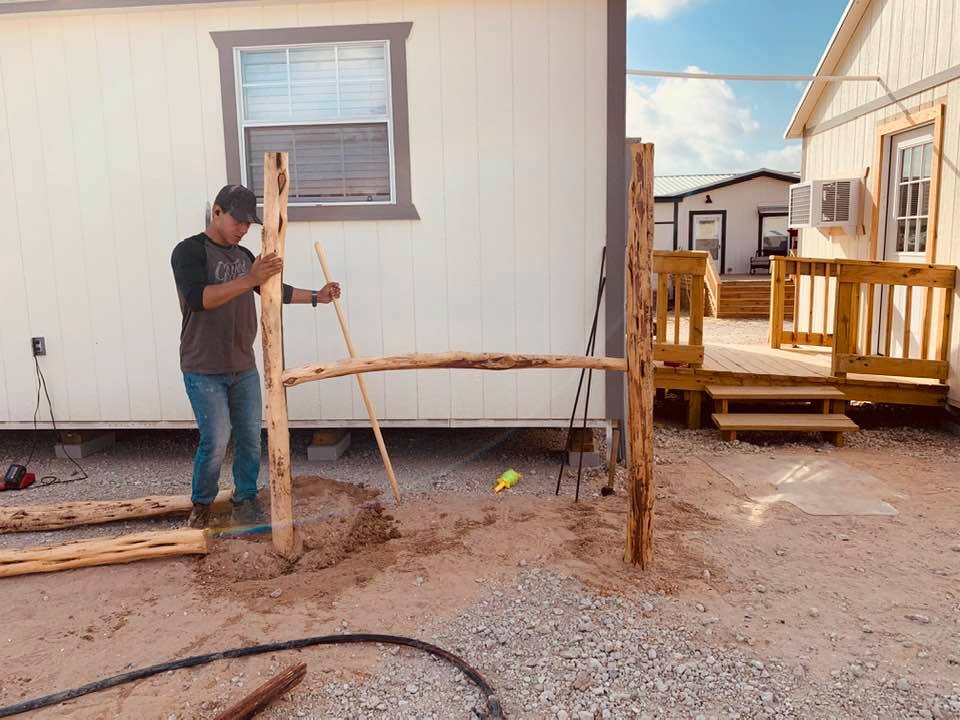 Seth of Top Notch Lawn Care constructs parking barriers out of cedar.