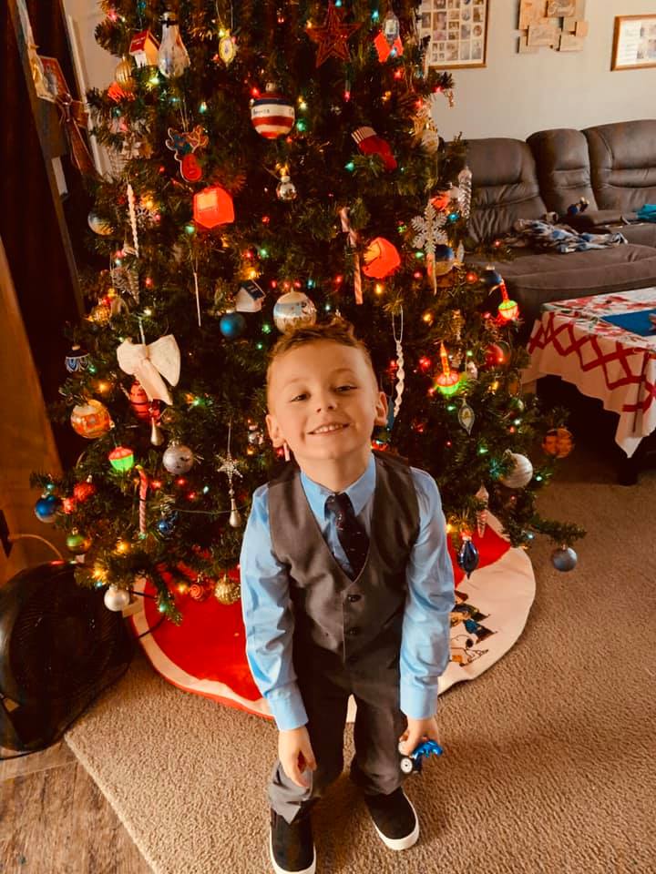Max in front of the tree in his new Christmas clothes.