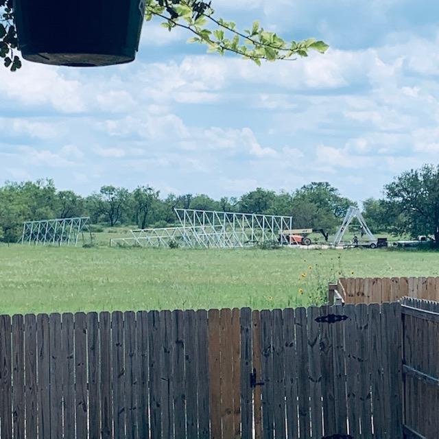 The men are hard at work in the heat building the cell tower.