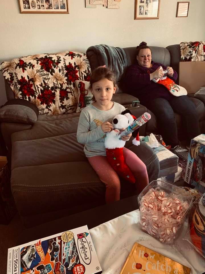 Holley shown with her mom opening Christmas gifts.