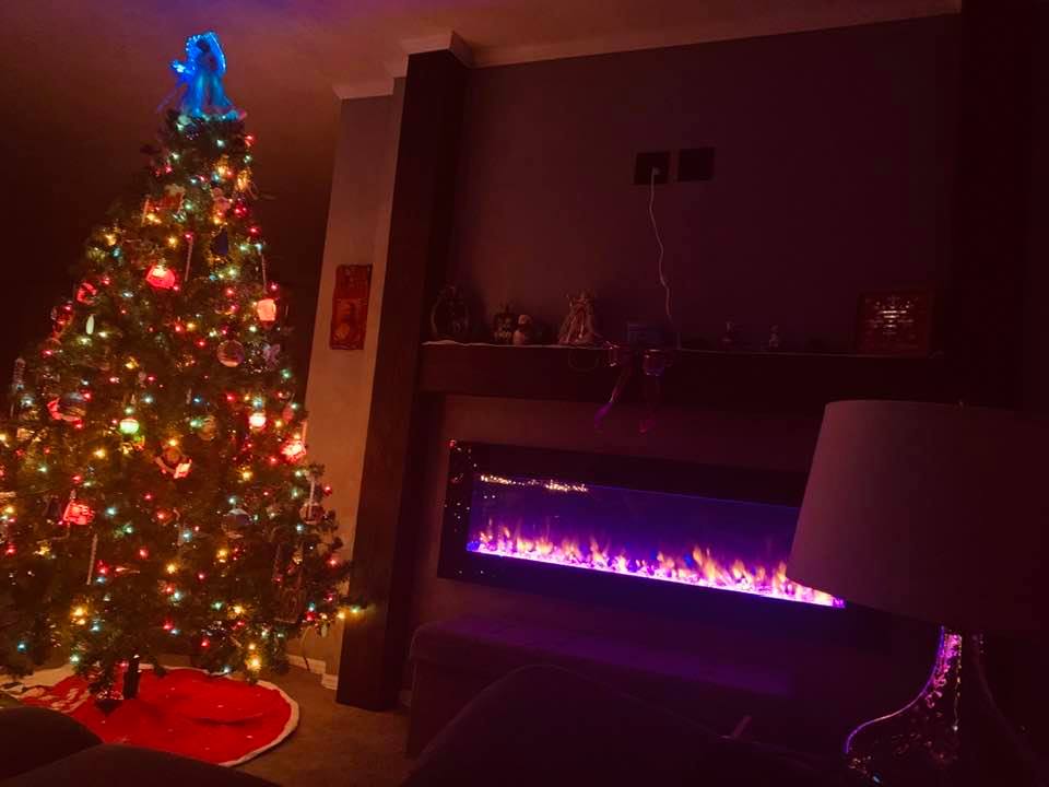 Our Christmas tree and living room fireplace light the room up while we watch Christmas movies.