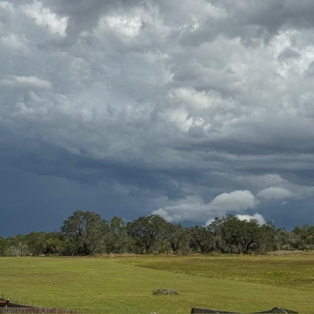 Storm clouds over the freshly mowed, new property. Isn't it pretty?