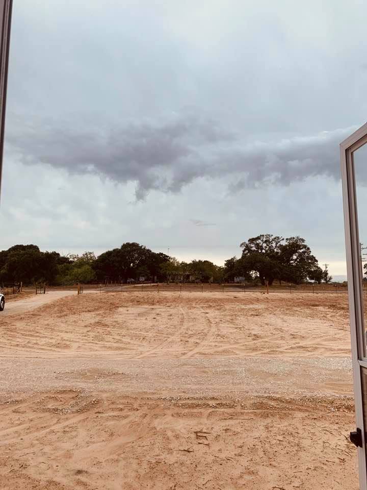 Cloudy day looking out front door of farm house to Farm to Market Road 2504.