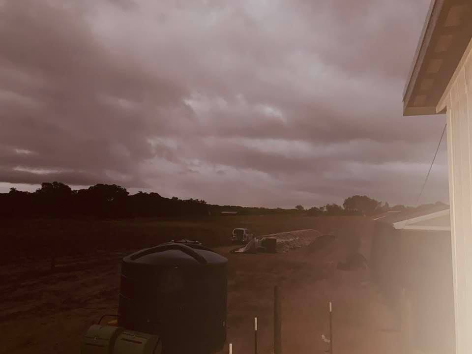 The wind blew the plastic off of the greenhouse so David had to park the SUV on it so it would not blow completely away. It was clipped on.