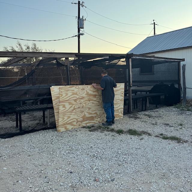 Matt grabs some plywood for the wall.