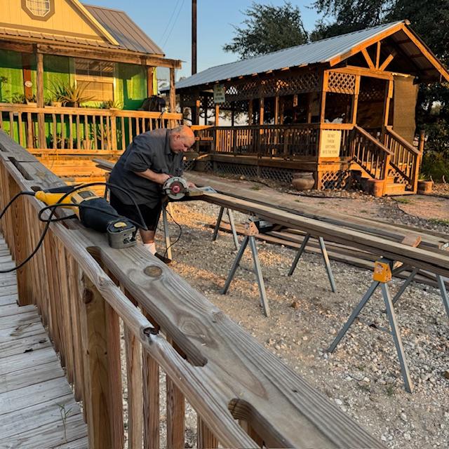 David saws a board for the wall frame.