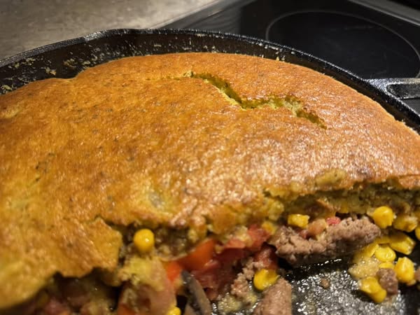 Corn bread freshly baked in a 10 inch cast iron skillet.
