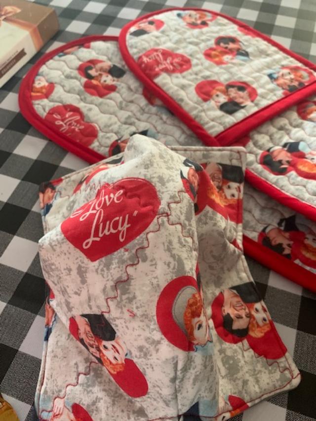 Look at this I Love Lucy cloth! I love it. The cozy is upside down with grey lined inside for the bowl of soup. The double potholder is there to bring baked goods out of the oven.