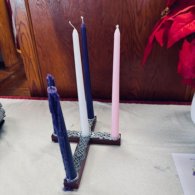 The Advent Wreath is in the shape of a cross at the church.