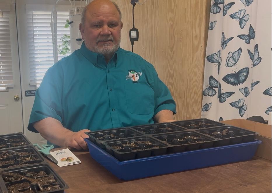 David was planting tomato seeds in his best David's Garden Seeds® shirt.