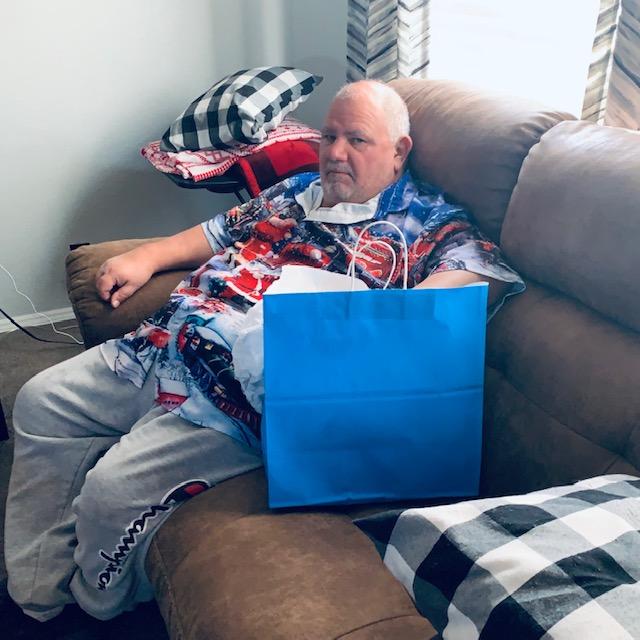 Here is David looking all cheerful as he opens a gift! LOL! He only smiled off camera.