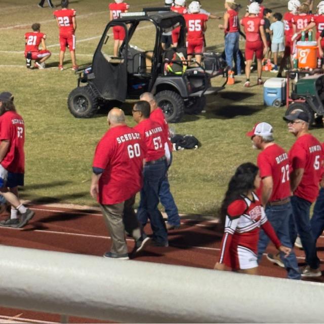David, #60, and Mario walk out to the blowup to enter the field.