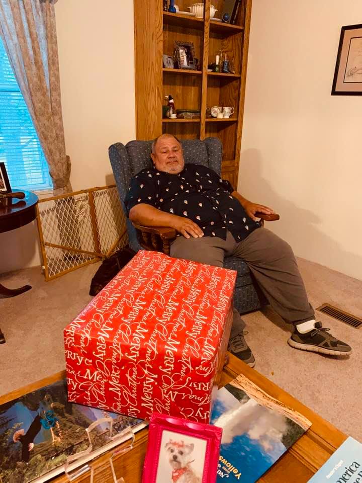 David sitting in Dad's living room. The gift is the lantern and candle holder that David's sister made us. They are beautiful.