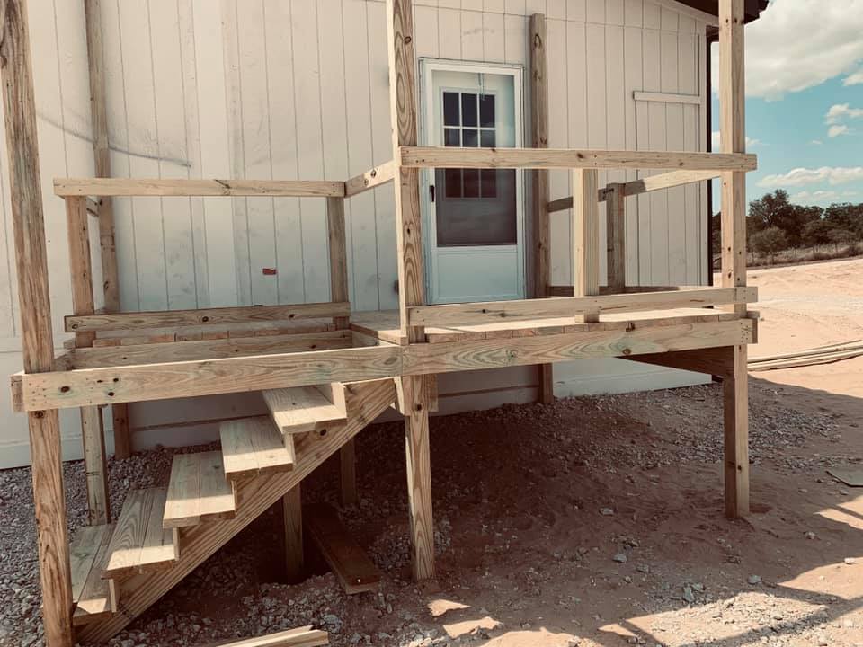 A new side deck with good stairs was built for us today but it is not finished yet. The rickety stairs are now at the front door. A new side deck with good stairs was built for us today but it is not finished yet. The rickety stairs are now at the front door.