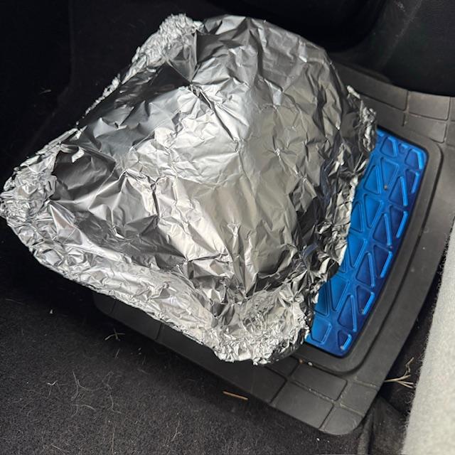 The hot, deep fried turkeys were in foil pans wrapped tightly with foil. This one is sitting on the floor of the truck, waiting for David to take us home to eat it.