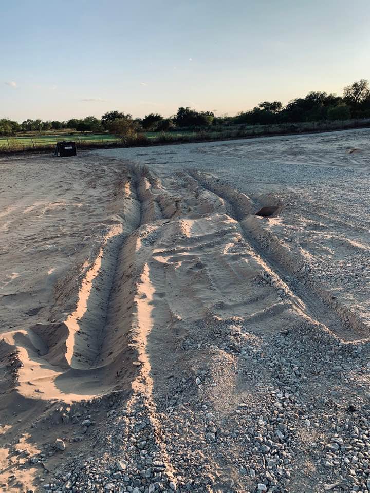 Deep tracks where the FedEx man got his truck stuck in the sand in our front yard. Stay on the driveway!