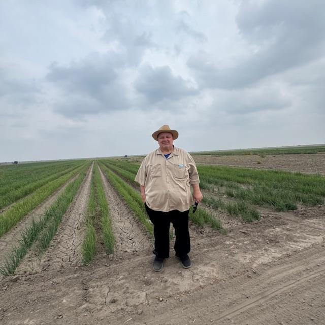 David is standing out on one of the many onion start fields at Dixondale.