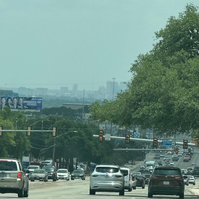 A view of the downtown San Antonio skyline and lots of traffic.