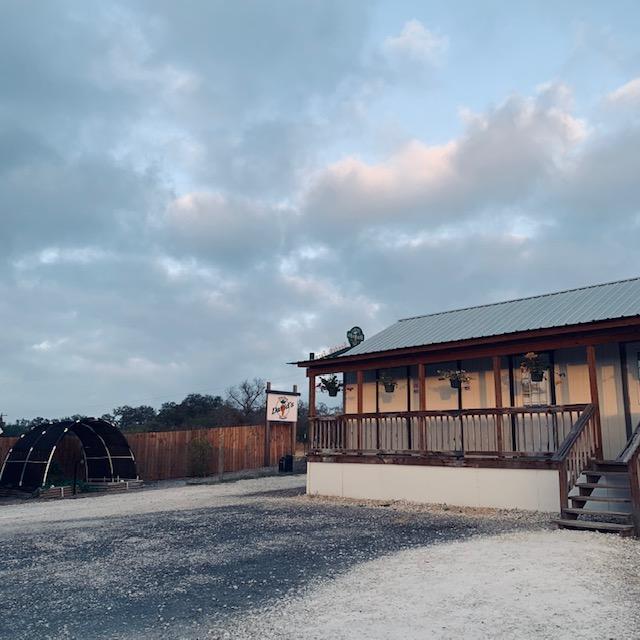 It was a bit cloudy this morning. Looking toward the gate and the Kitchen building at an empty parking lot before everyone arrives.