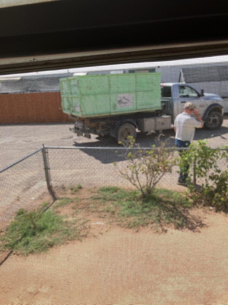 The small dumpster arrives at the house.
