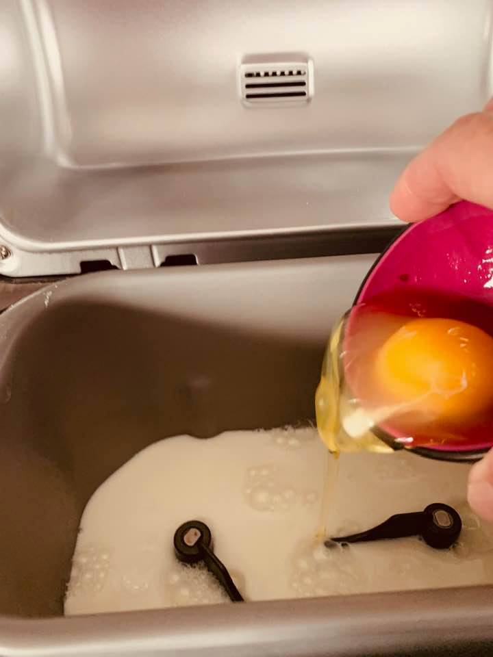 Egg going in after the milk has been poured into the pan.