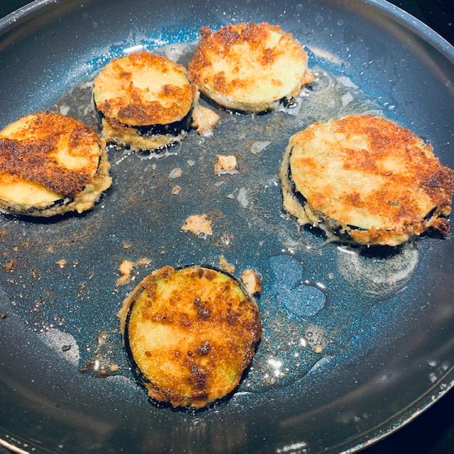 Fry each slice of eggplant until golden brown.