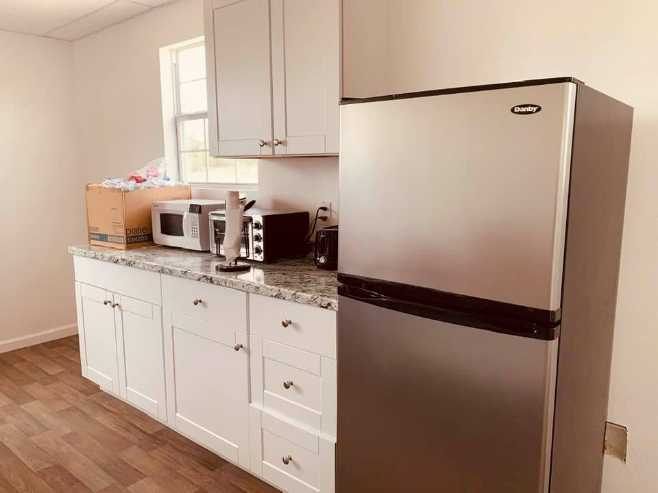 The breakroom as it looks today. Once the sink comes in, it will go where the box of cups is now.
