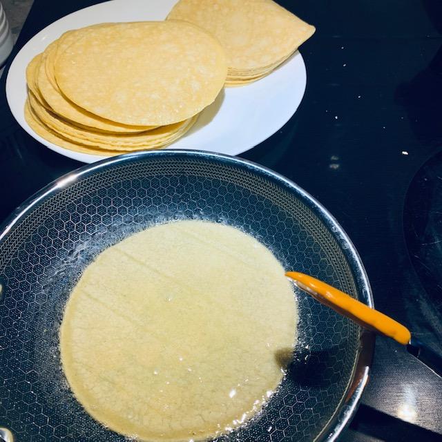 Make sure both sides go into the oil for 10 to 15 seconds. Then place on plate and repeat with each tortilla.