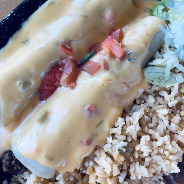 These enchiladas are covered in queso sauce.
