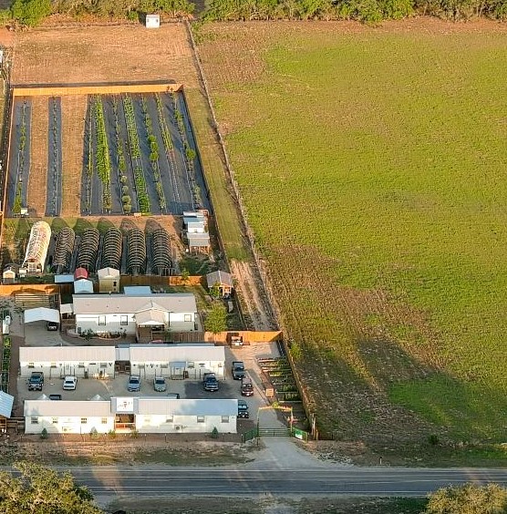 This is a drone shot of our original 4 acres plus on the right is the next 4 acres that we bought with FM 2504 running in front of it. 9 buildings have been sold now.