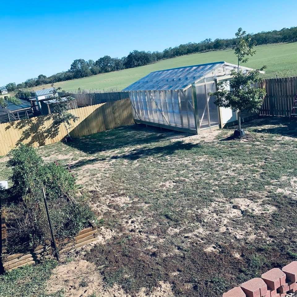 The finished greenhouse is in a new corner that our yard did not have before. It looks good. Think of all the garden vegetables we can grow here!