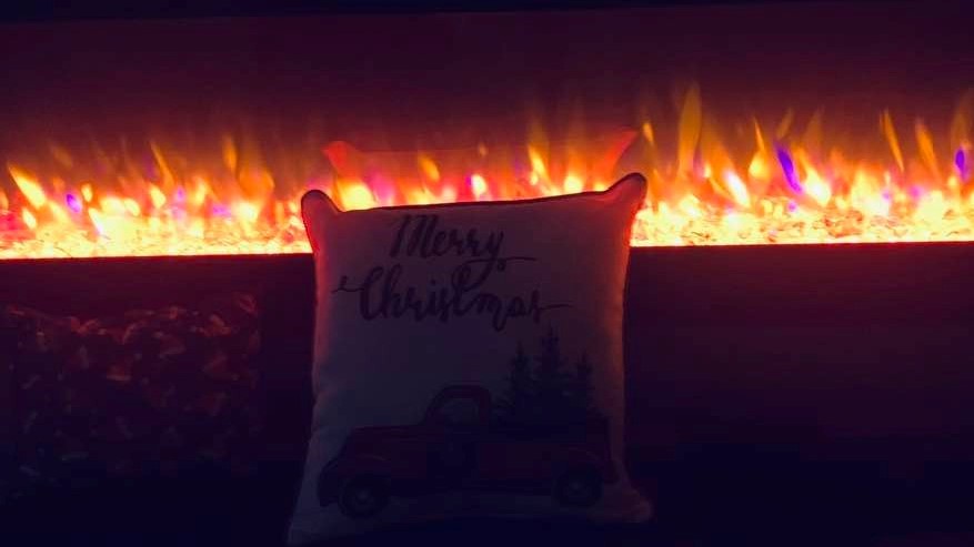 We have an electric fireplace and I added a Christmas pillow for one of our Christmas decorations.