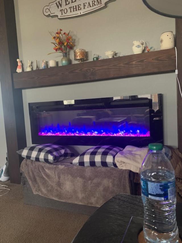 I am set up on the couch with some water in front of our pretty fireplace.