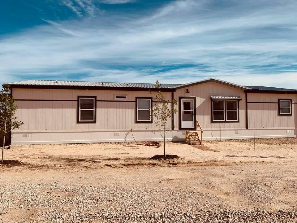 Our small farm home with a few of our new oak trees. We will put our business and store in front of our home.