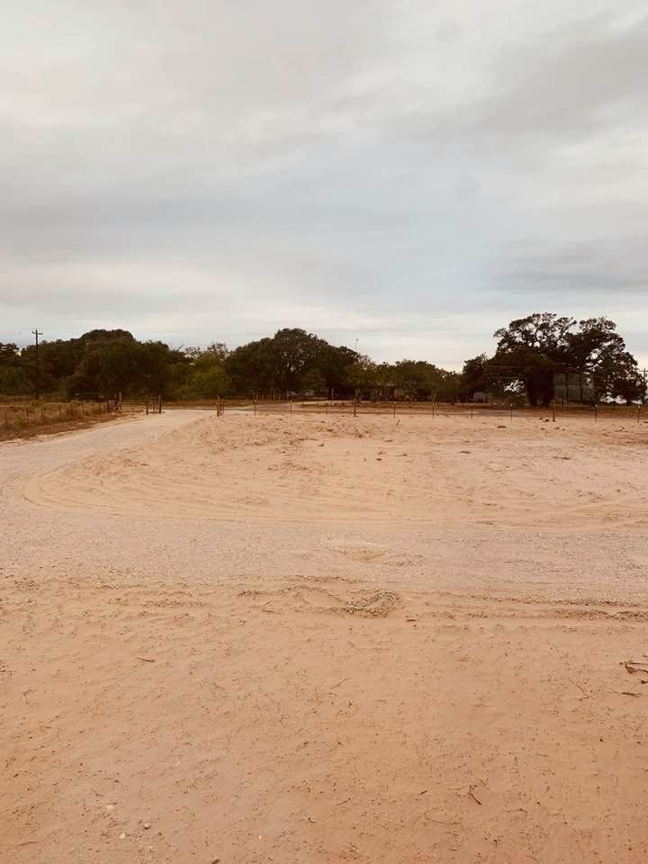 Our sandy front yard and what is left of our driveway. We will have it redone as soon as all of the big trucks are finished with stuff on our farm.