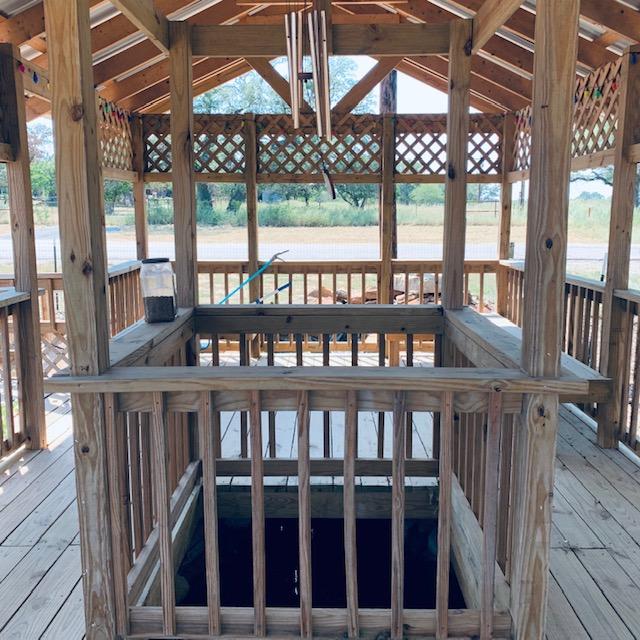 We're in the gazebo with the inner pond in front of us looking toward the pond with falls and the road. The 2 ponds hook together with a small river under the deck.