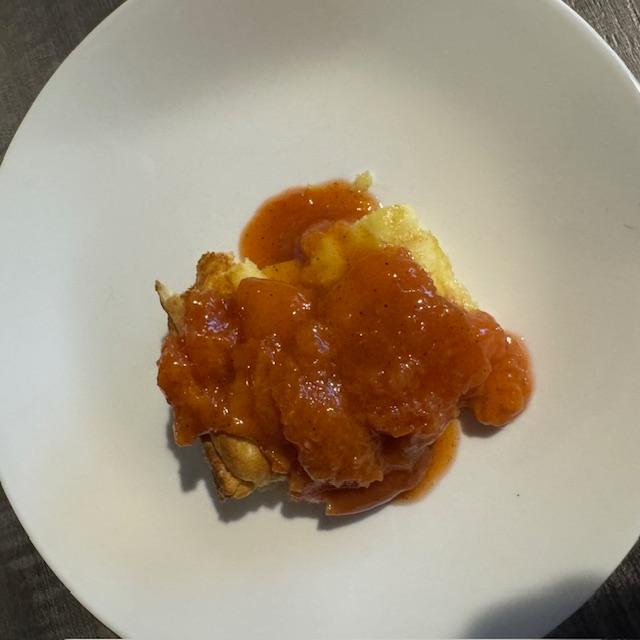 A serving of German pancake covered in peaches. So good!