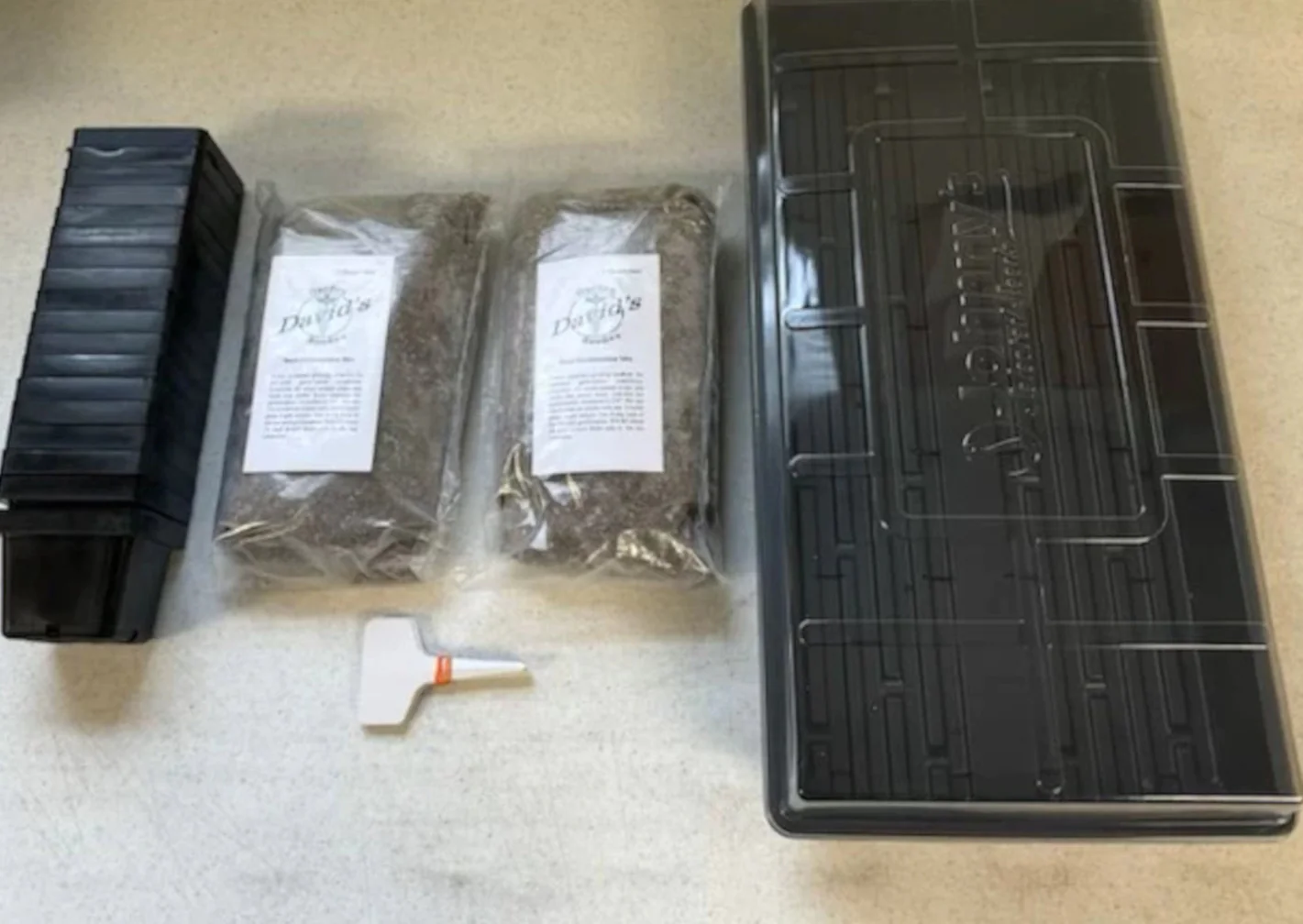 Our germination kit has everything-2 trays, 18 pots, a clear lid, germination mix, plant markers.